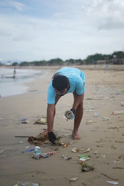 Man picking up garbage on the beach